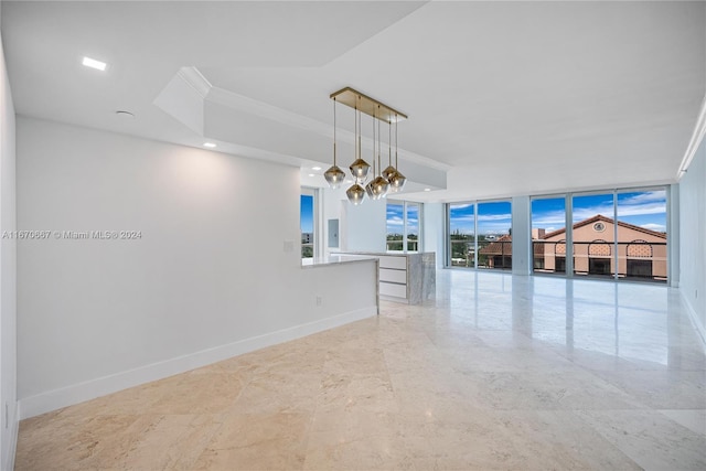 spare room featuring plenty of natural light and a wall of windows