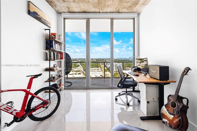 office with floor to ceiling windows, plenty of natural light, and light tile patterned floors