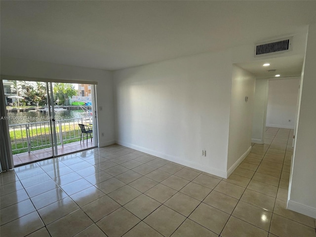 tiled empty room with a water view