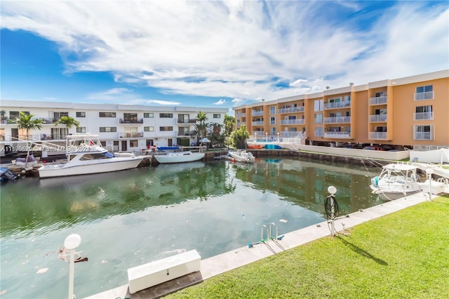 view of dock featuring a water view and a yard