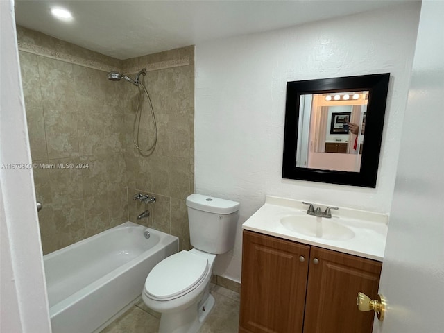 full bathroom featuring tile patterned flooring, vanity, tiled shower / bath combo, and toilet