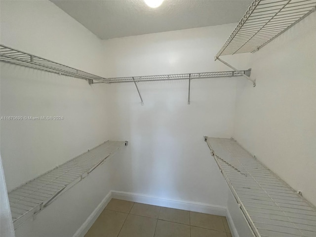 walk in closet with tile patterned floors