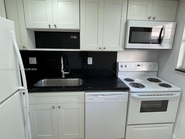 kitchen featuring backsplash, white cabinetry, sink, and white appliances