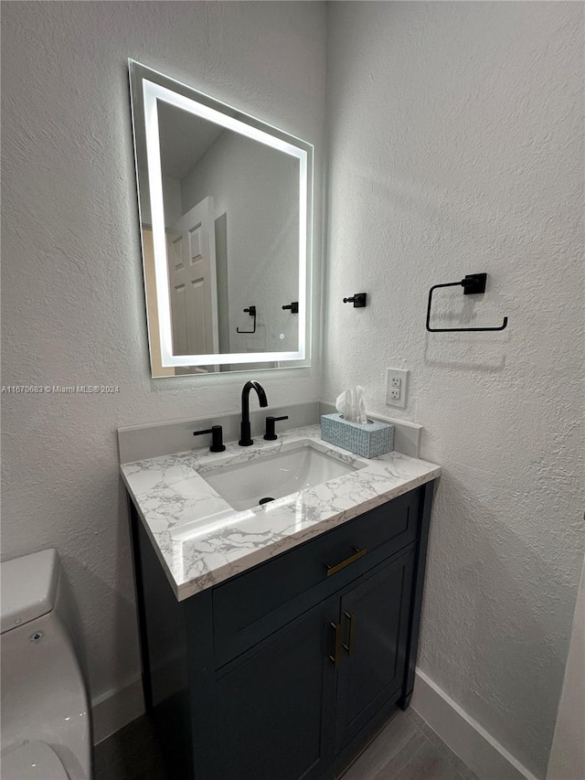 bathroom featuring vanity and toilet