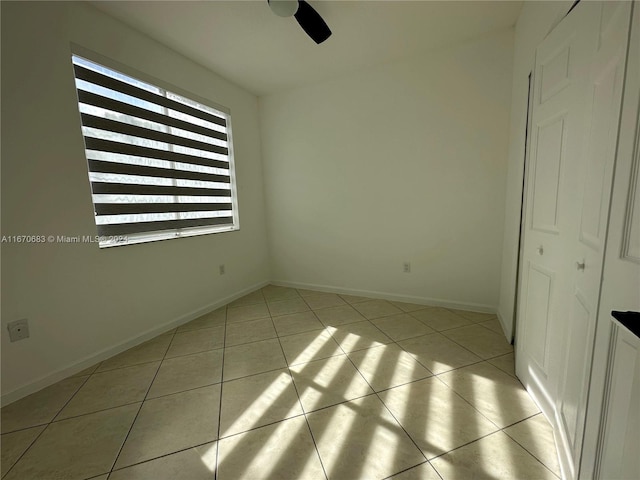 unfurnished bedroom featuring light tile patterned flooring and ceiling fan