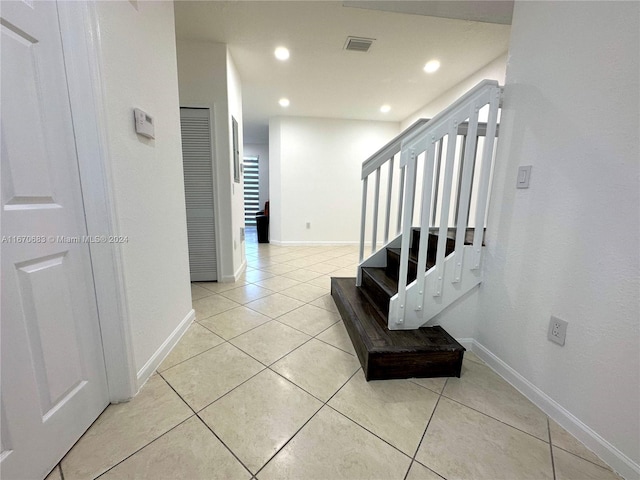 corridor with light tile patterned flooring