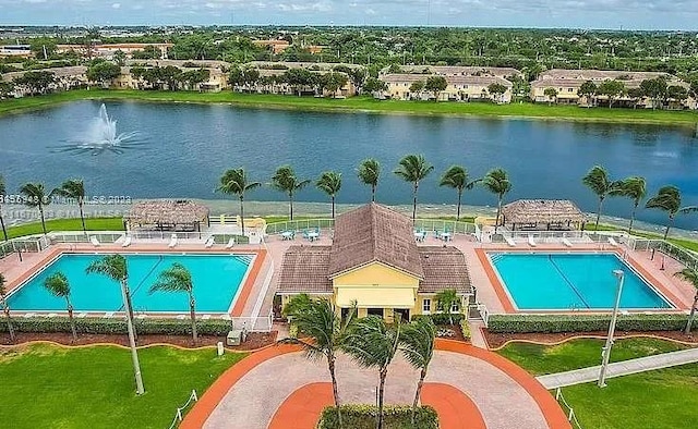 view of swimming pool with a gazebo, a water view, and a patio area