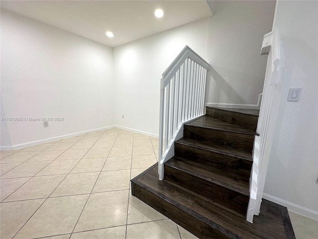 stairs featuring tile patterned floors