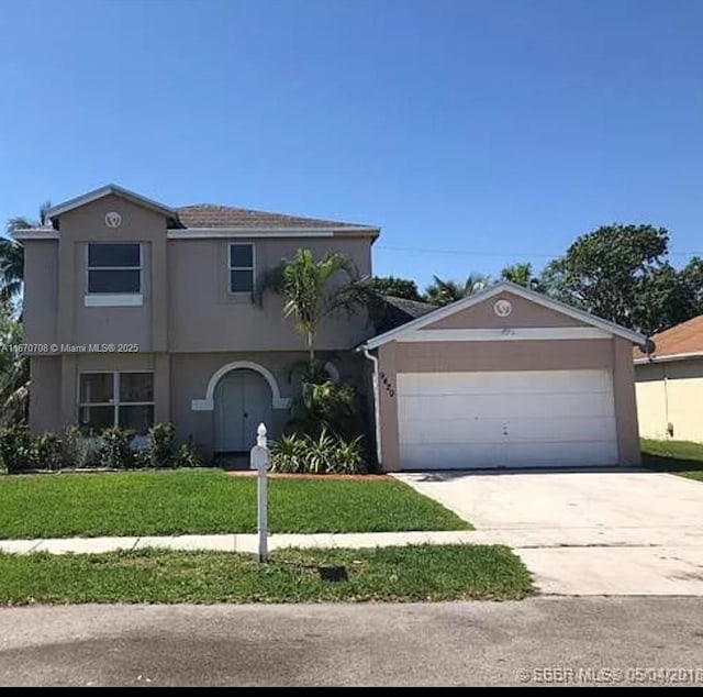 front facade featuring a garage and a front yard