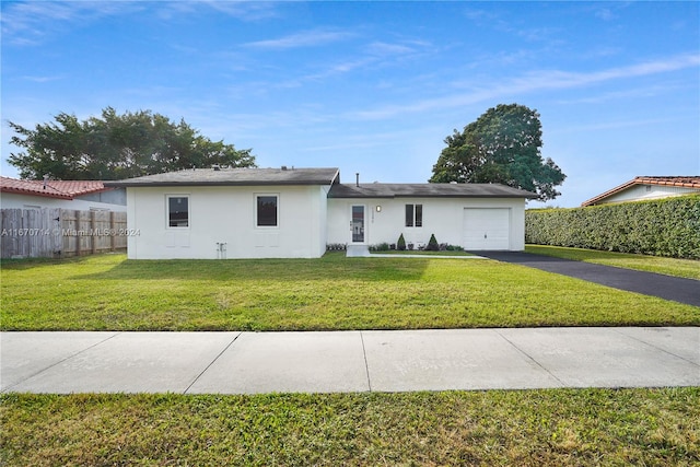 view of front of home with a garage and a front lawn