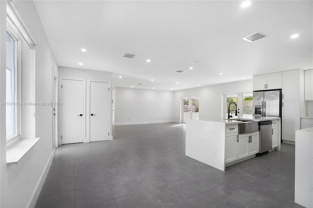 kitchen featuring white cabinetry, sink, a kitchen island with sink, and stainless steel appliances