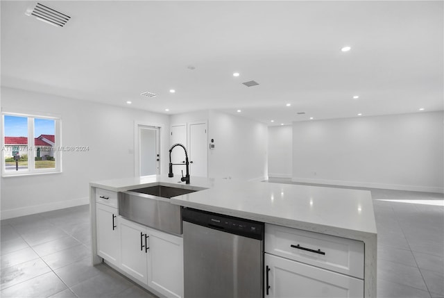 kitchen featuring white cabinetry, dishwasher, sink, light stone counters, and light tile patterned floors