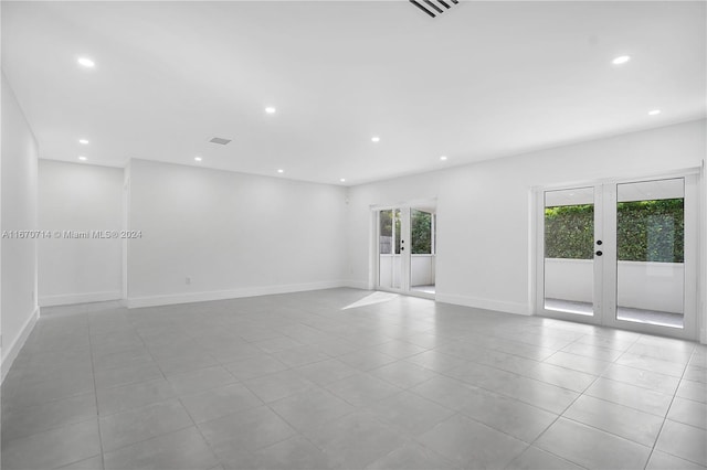 empty room with french doors and light tile patterned floors