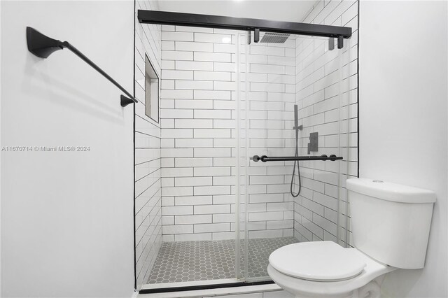 bathroom with toilet and walk in shower