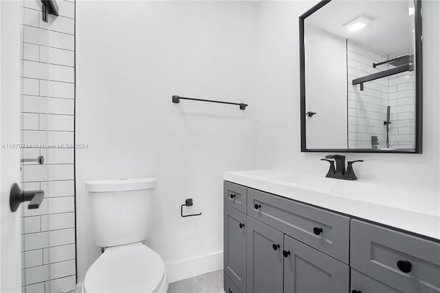 bathroom featuring tile patterned floors, toilet, vanity, and walk in shower