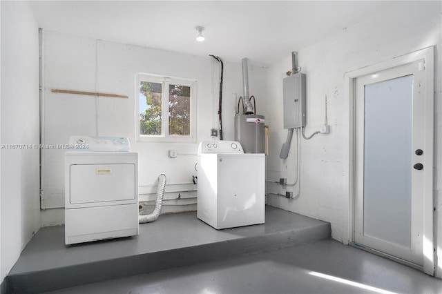 washroom featuring gas water heater, washing machine and dryer, and electric panel