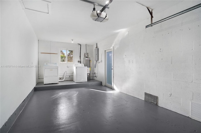 garage with gas water heater, electric panel, a garage door opener, and washer and clothes dryer