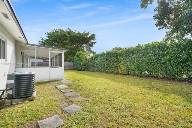 view of yard with a sunroom and cooling unit