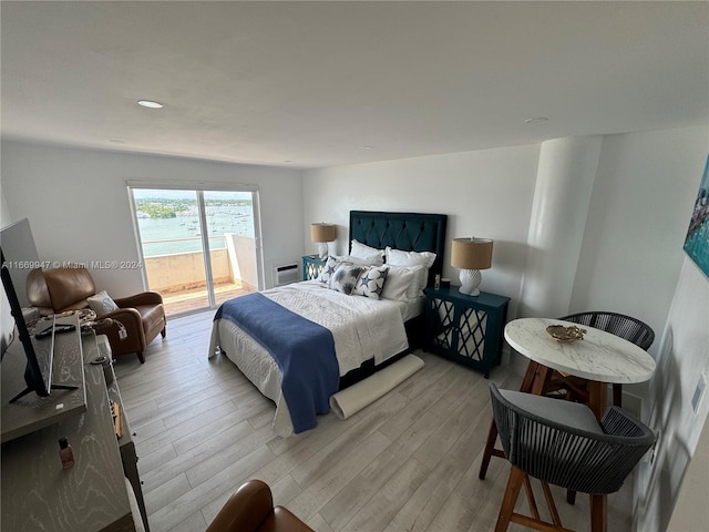 bedroom featuring light hardwood / wood-style floors and access to exterior