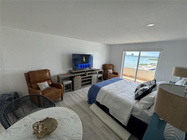 bedroom with light hardwood / wood-style flooring and access to exterior