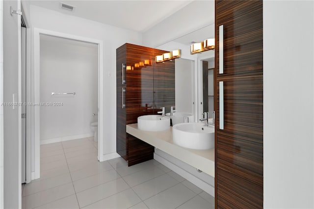 bathroom with tile patterned flooring, vanity, and toilet