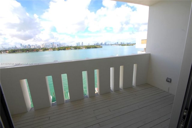 wooden terrace featuring a water view