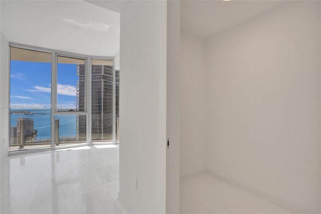 empty room featuring floor to ceiling windows and a water view