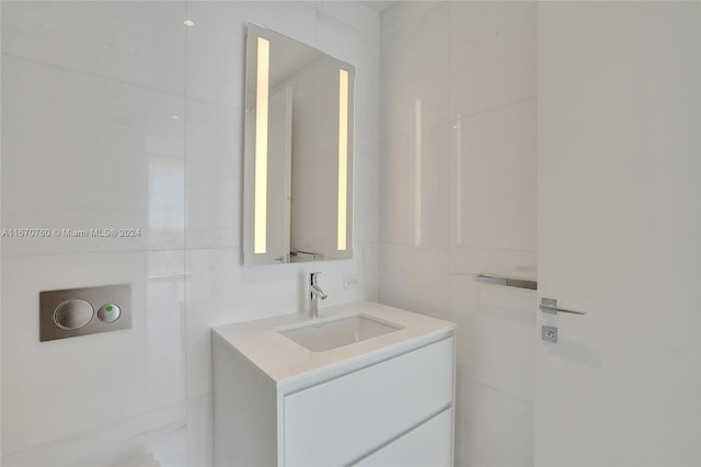 bathroom featuring tile walls and vanity