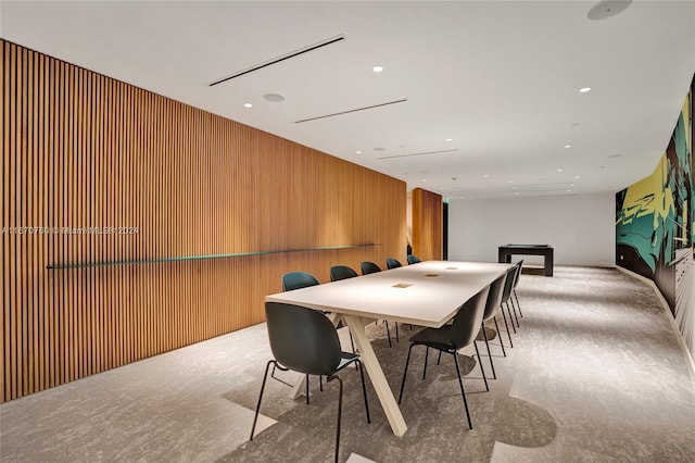 recreation room with light colored carpet and wooden walls