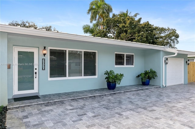 view of exterior entry with a garage