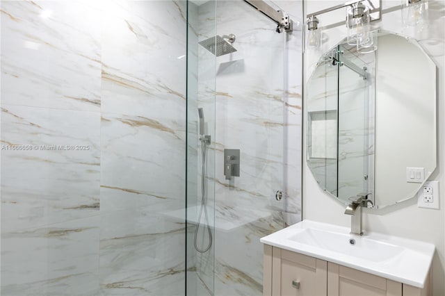 bathroom featuring a shower with door and vanity