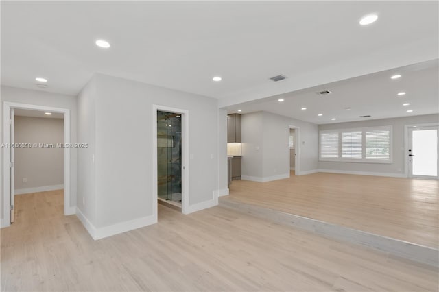 unfurnished living room featuring light hardwood / wood-style floors