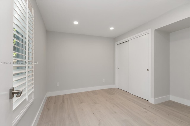 unfurnished bedroom featuring a closet and light hardwood / wood-style flooring