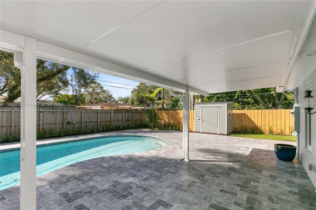 view of swimming pool featuring a storage unit and a patio