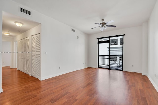 spare room featuring ceiling fan and dark hardwood / wood-style floors