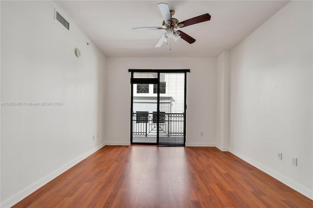 unfurnished room featuring dark hardwood / wood-style flooring and ceiling fan