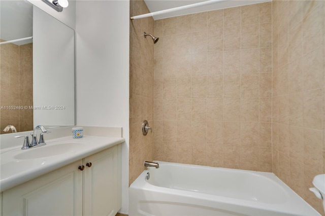 bathroom with vanity and tiled shower / bath