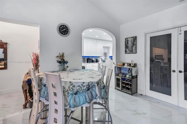 dining space featuring vaulted ceiling