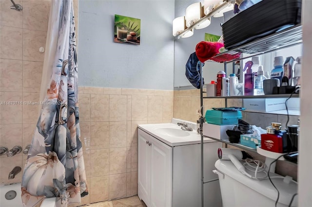 bathroom with vanity, tile walls, and toilet