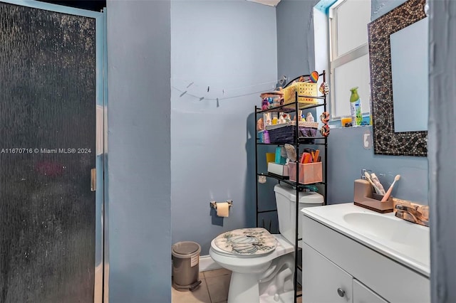 bathroom with walk in shower, tile patterned flooring, vanity, and toilet