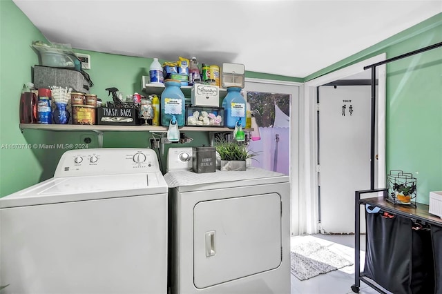 clothes washing area with washing machine and dryer