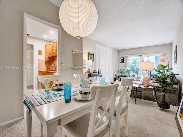 dining space featuring light colored carpet, pool table, and sink