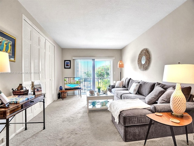 living room with light colored carpet and a textured ceiling