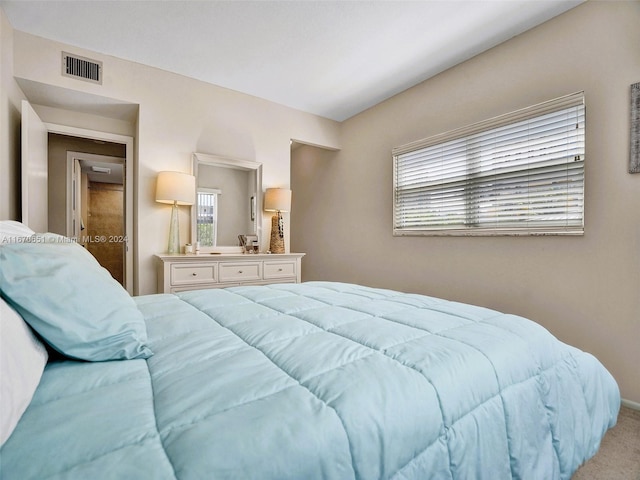 bedroom featuring light carpet