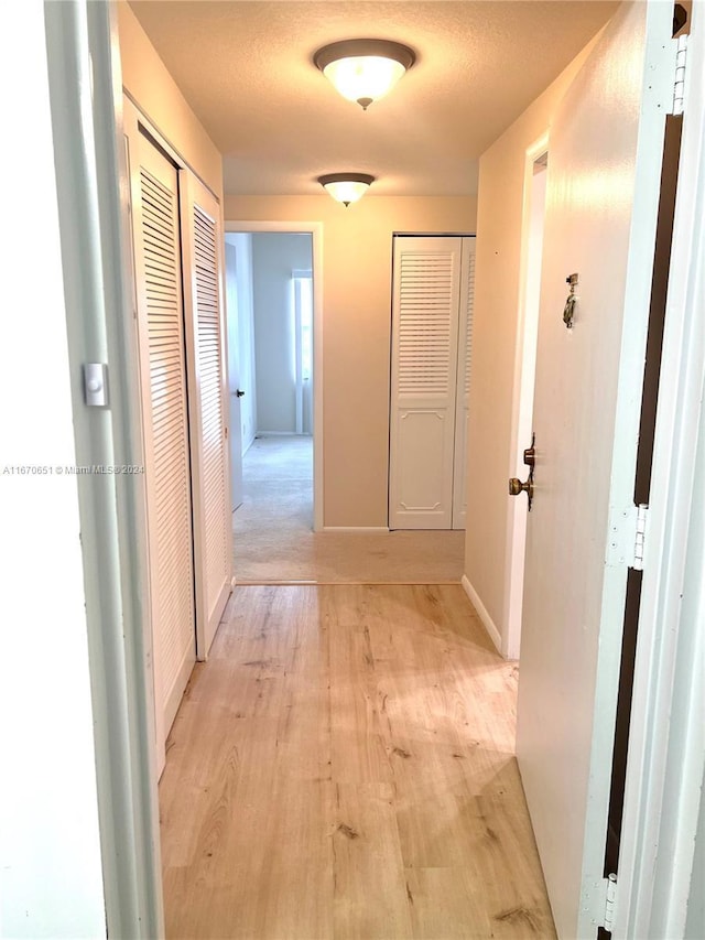 corridor featuring light hardwood / wood-style floors