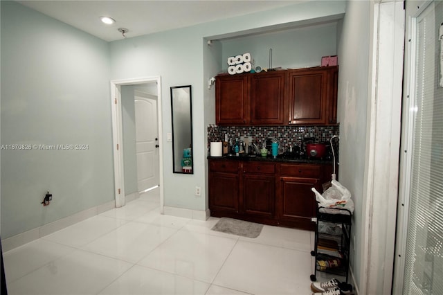 kitchen featuring backsplash and light tile patterned flooring