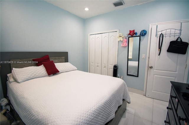 bedroom with a closet and light tile patterned floors