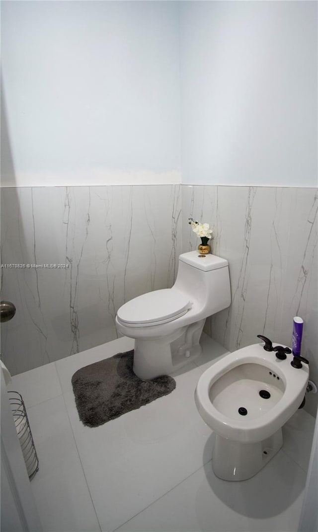 bathroom featuring a bidet, walk in shower, and toilet