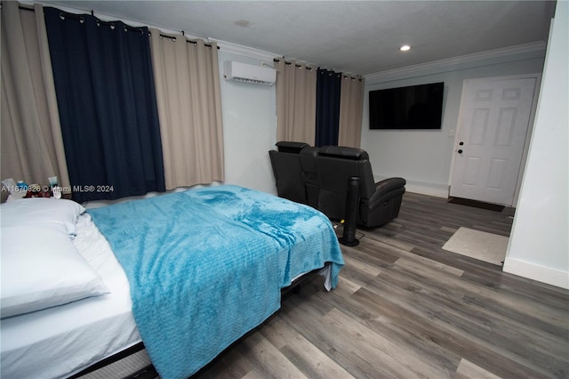 bedroom featuring an AC wall unit, ornamental molding, and hardwood / wood-style floors