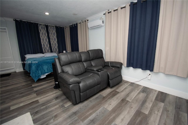 living room with a textured ceiling, hardwood / wood-style flooring, and a wall mounted AC